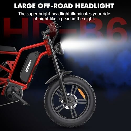 Red off-road bike with bright headlight on dark background